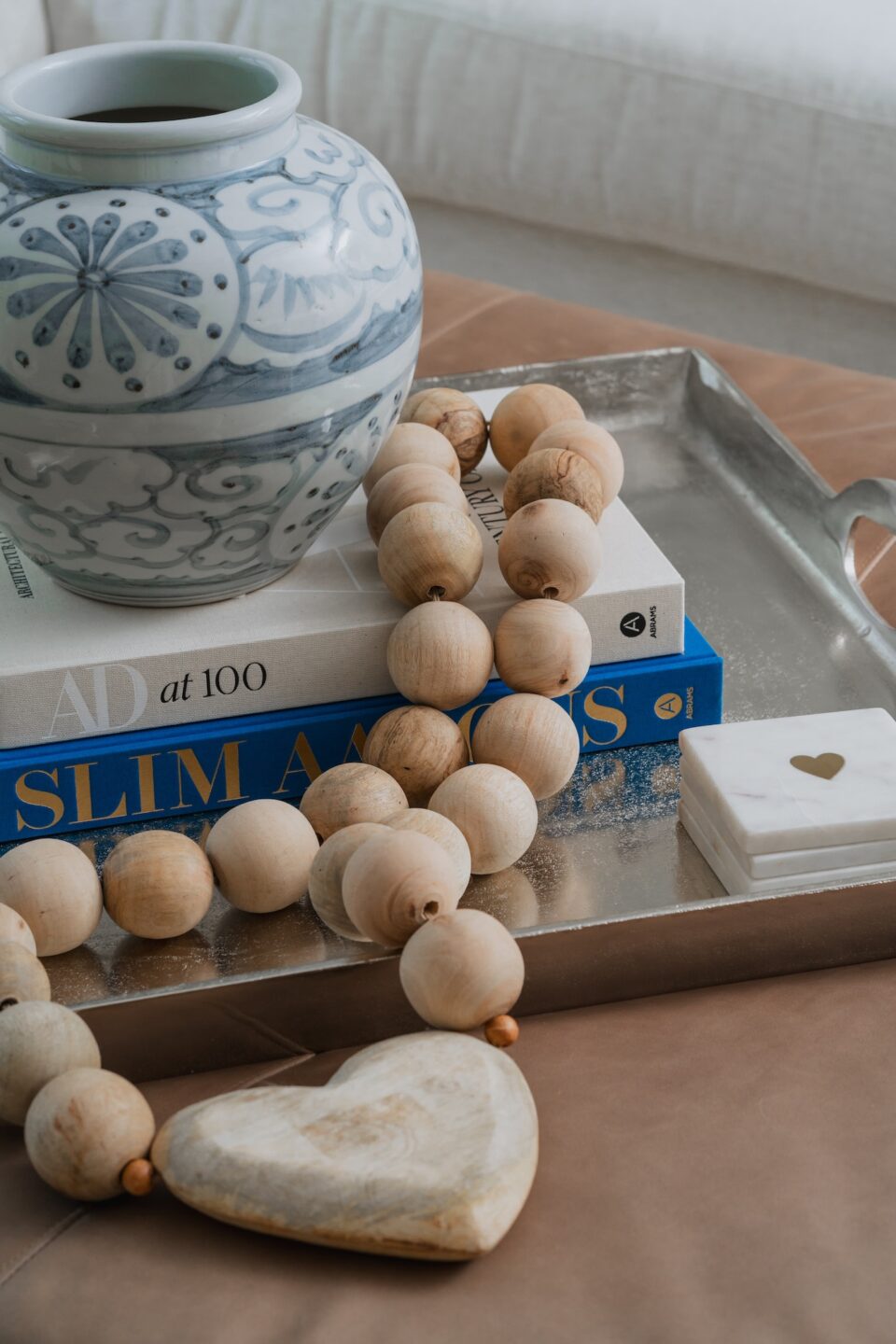 Close Up Of Wood Beads And Coffee Table Books