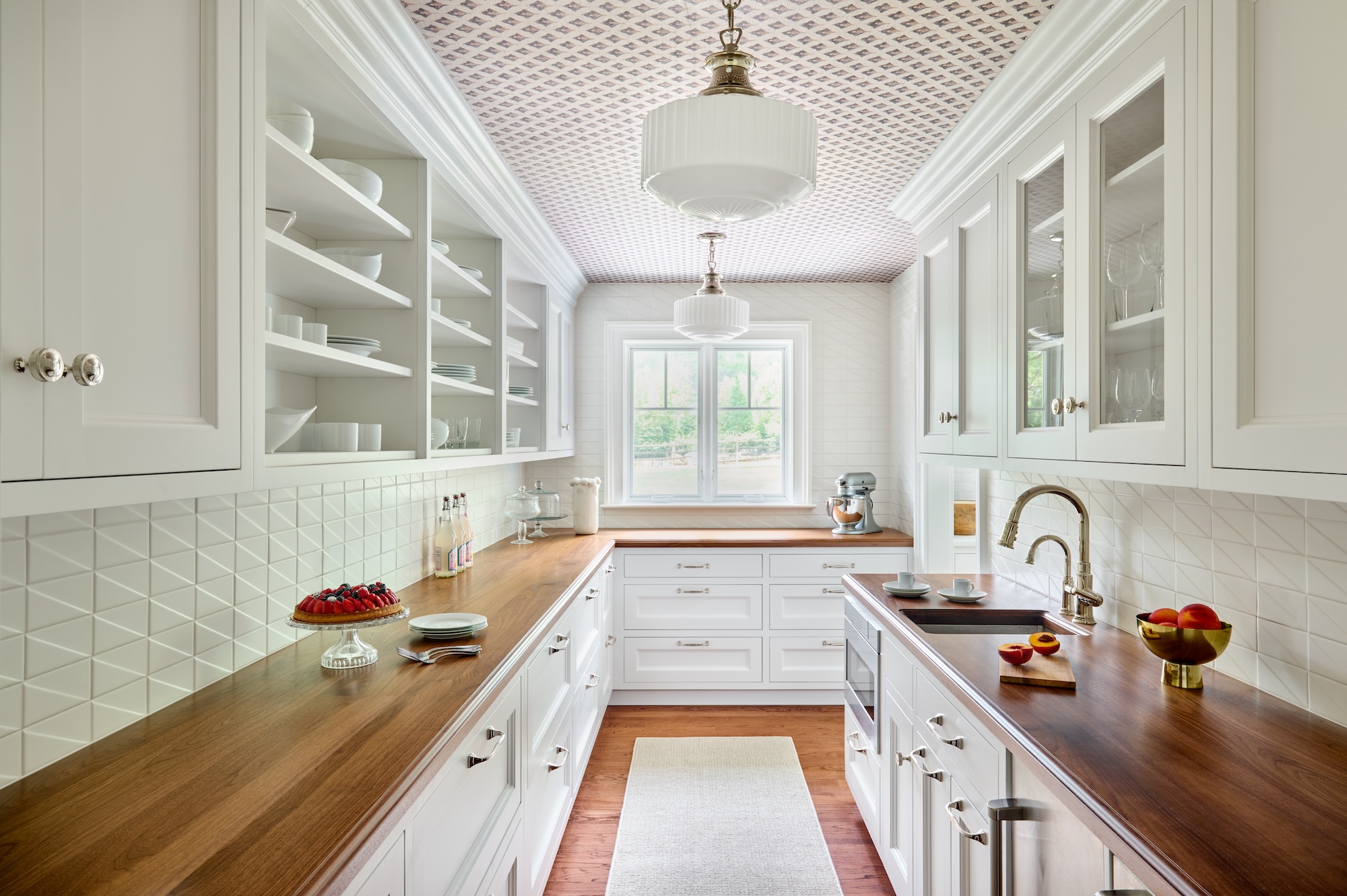 large walk in butlers pantry with custom cabinetry wostbrock home