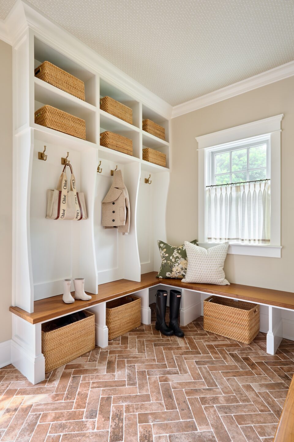 mudroom design with brick floor and custom storage