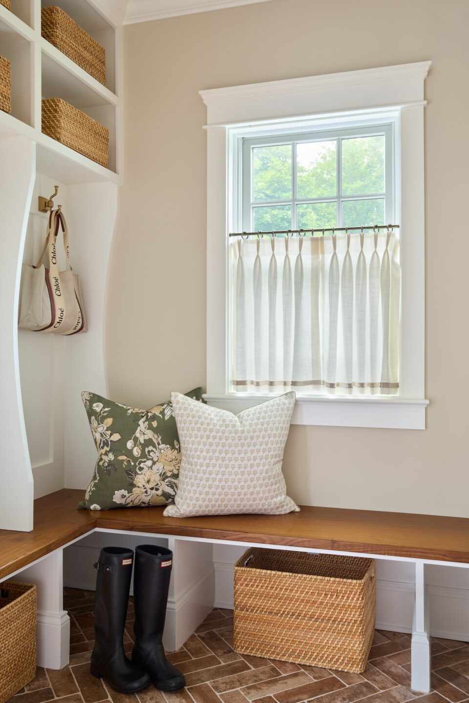 mudroom design with brick floor and custom storage wostbrock home